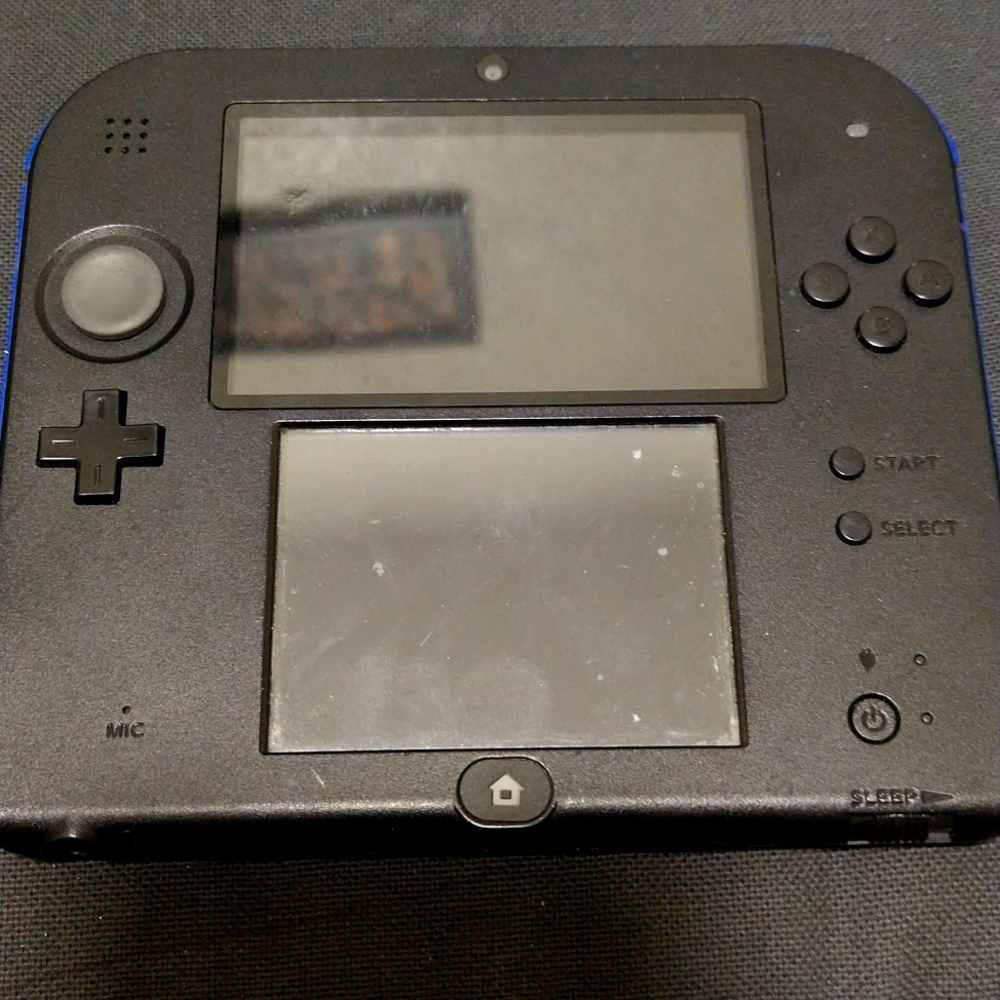 Nintendo 2DS with super smash brothers game.
